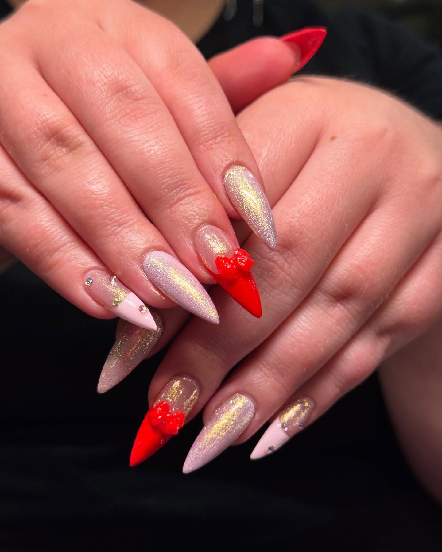 A close up of a woman 's nails with a red heart on them