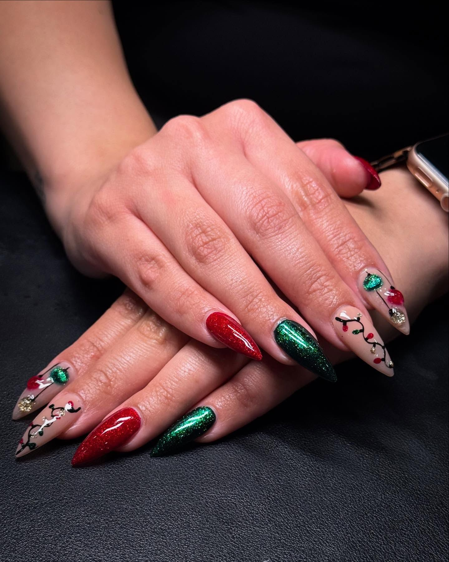 A close up of a woman 's hands with christmas nails