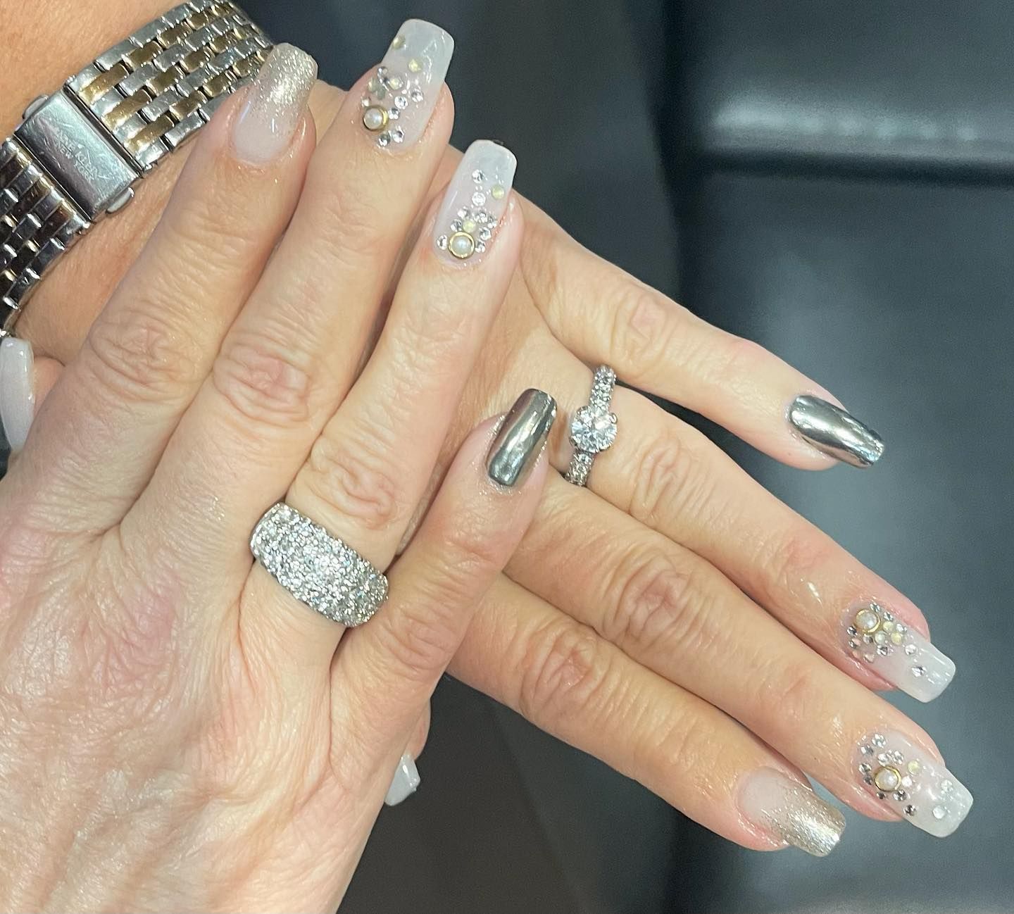 A close up of a woman 's nails with a watch on her wrist