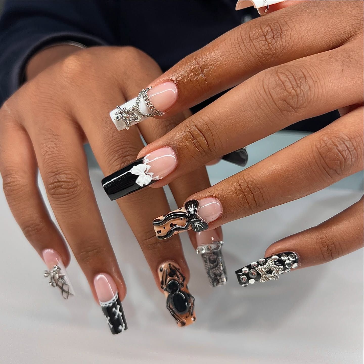 A close up of a woman 's nails with different designs on them
