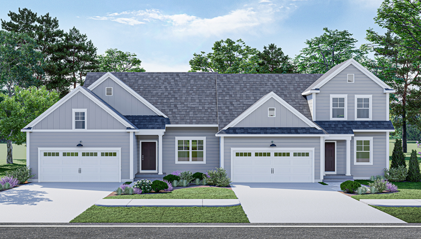 Two-unit gray duplex with white garage doors, a dark roof, and landscaping.