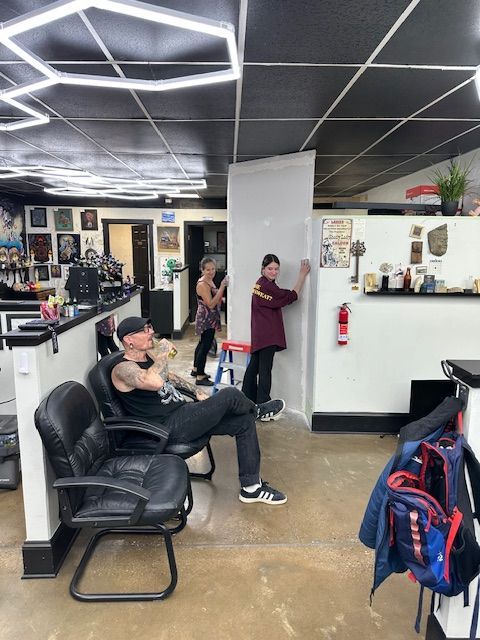A tattoo shop interior with three people
