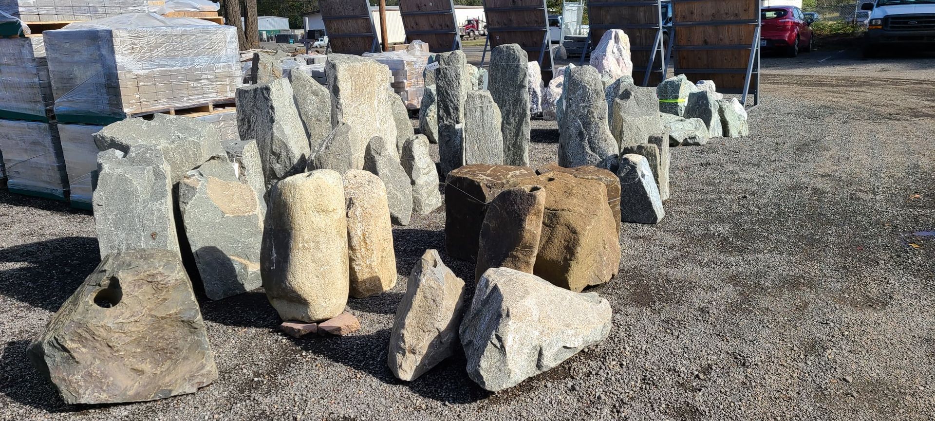 A pile of rocks sitting on top of a gravel road.