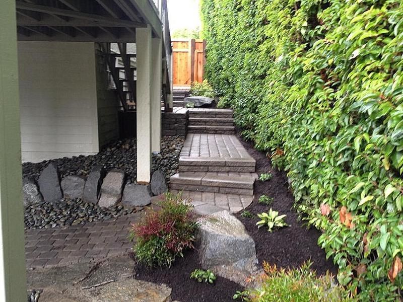 A wooden walkway with stairs leading up to a house