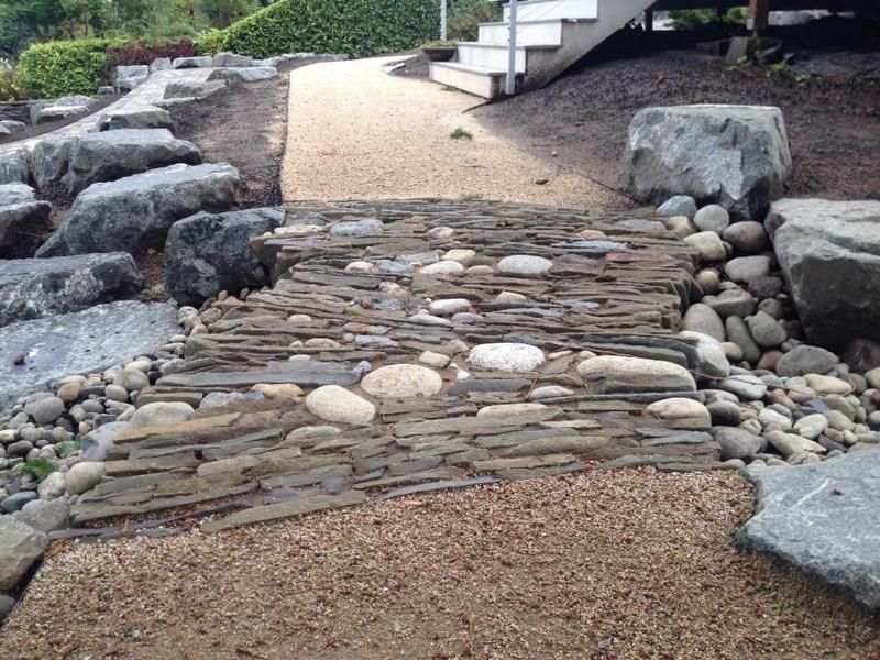 A stone walkway with stairs in the background