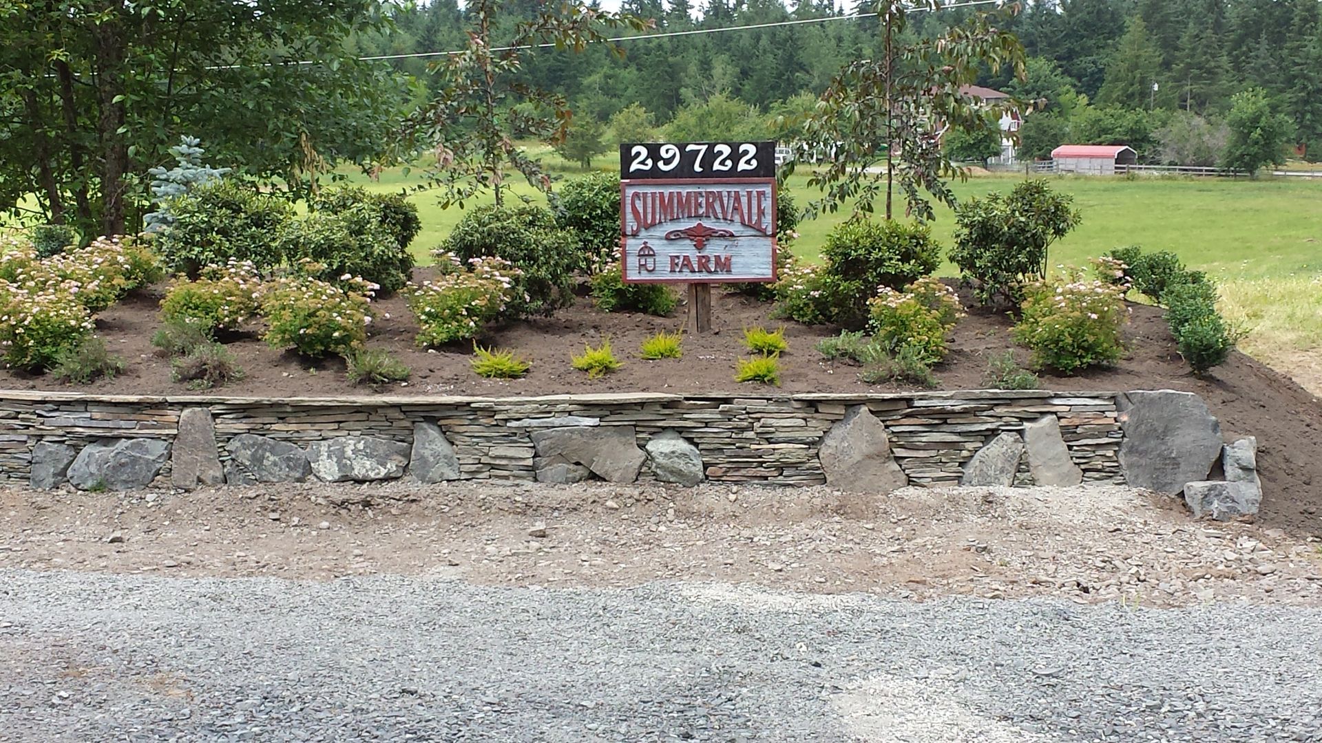 A stone wall with a sign that says summerland on it