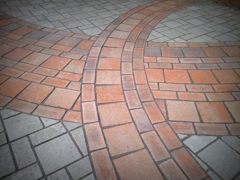 A close up of a brick floor with a circular pattern