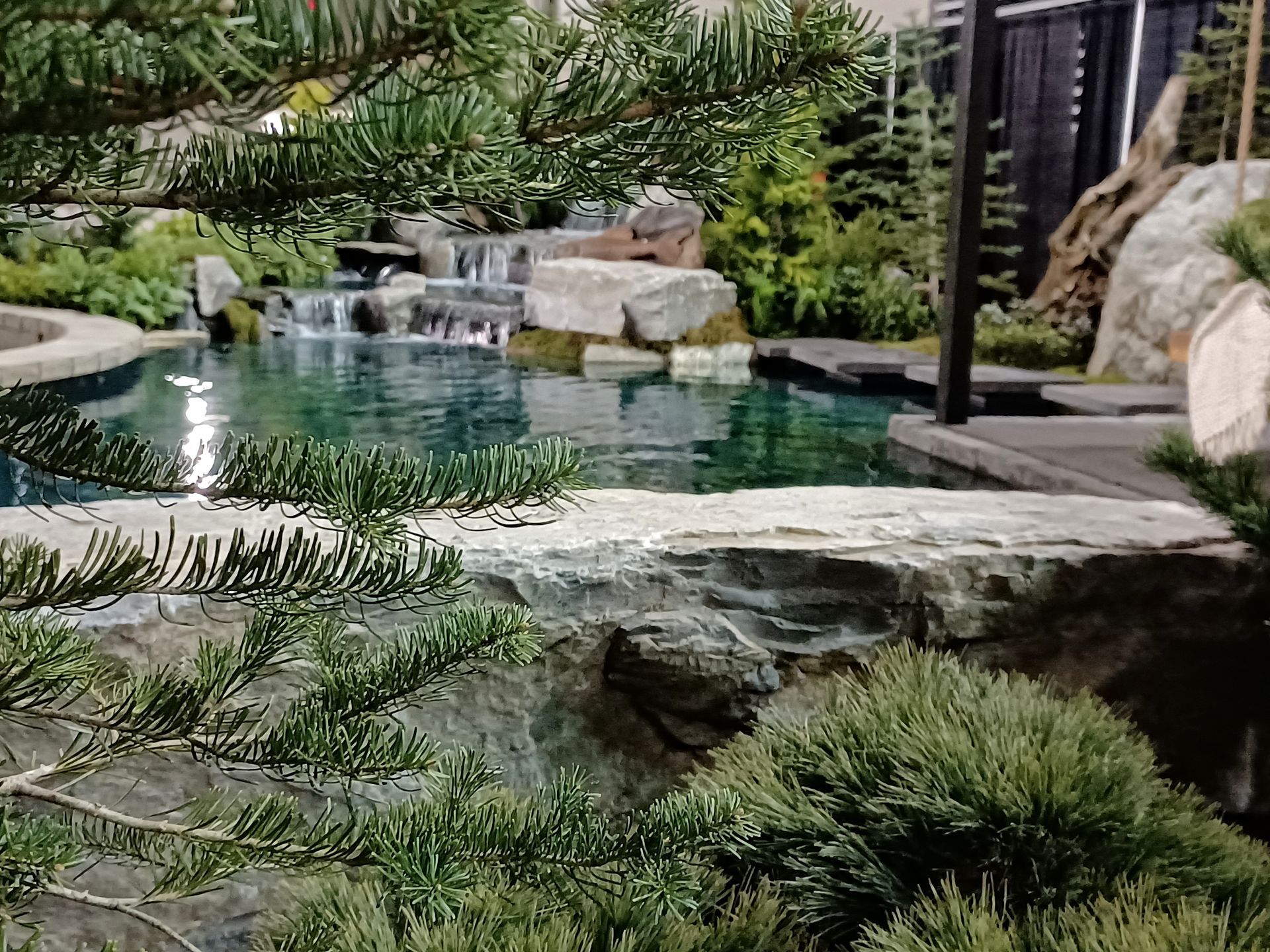 There is a waterfall in the middle of the garden.