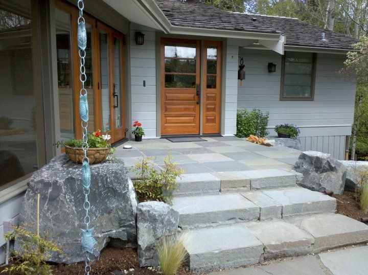A house with stairs leading up to the front door