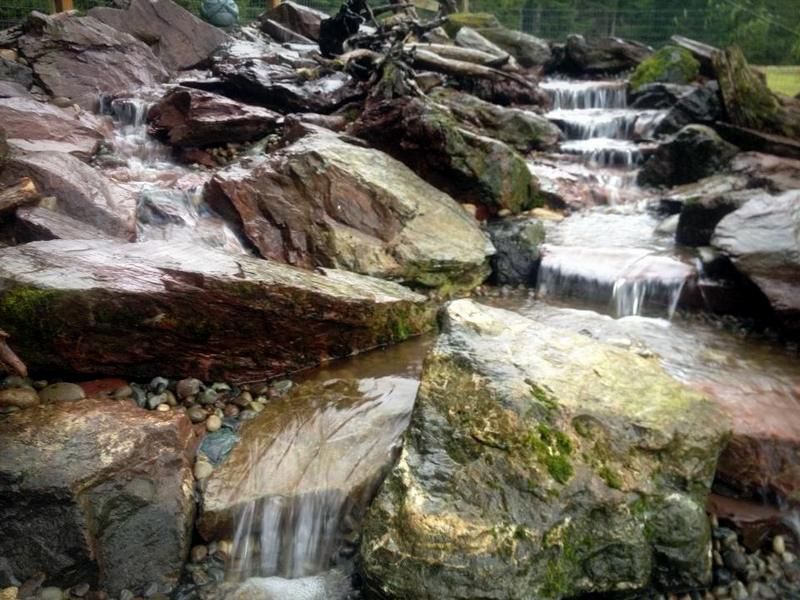 There is a waterfall in the middle of a rocky area.