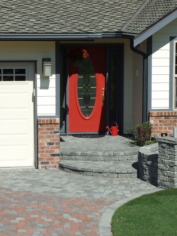 A house with a red door and a white garage door