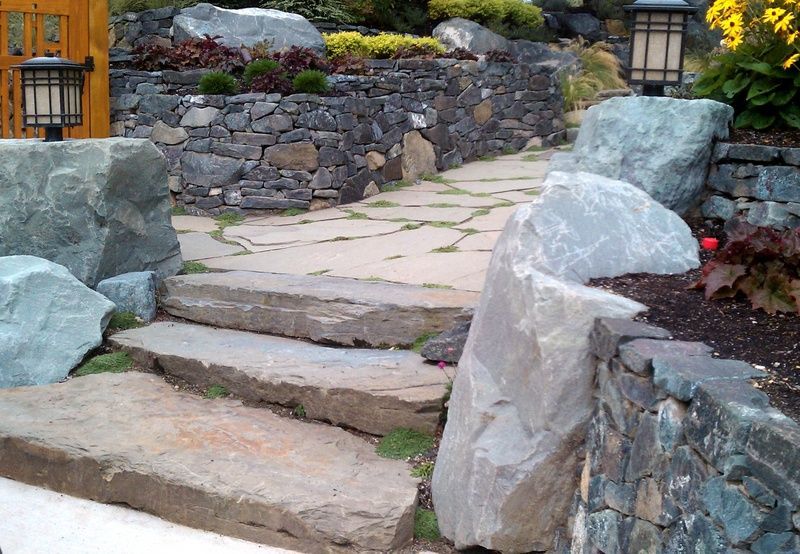 A stone walkway surrounded by large rocks and steps