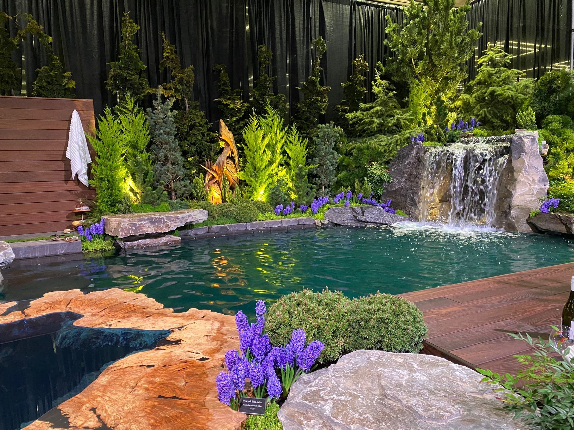 There is a waterfall in the middle of the pool.