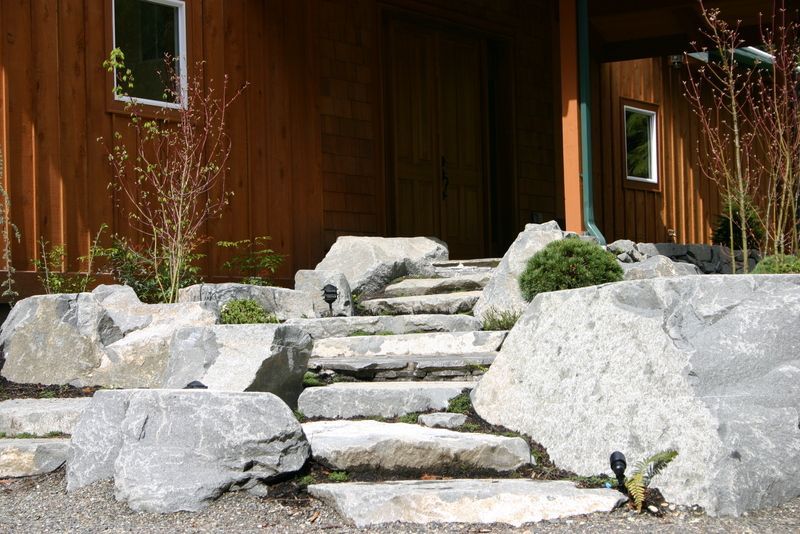 A set of stone steps leading up to a wooden house