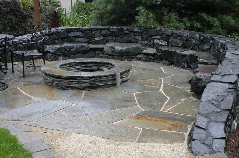 There is a fire pit in the middle of the patio.