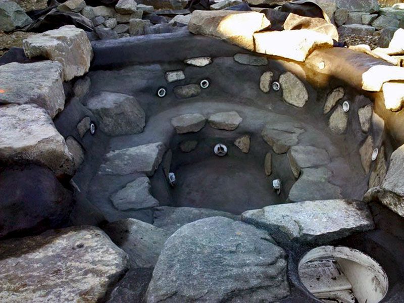 a rocky area with a hole in the middle of it