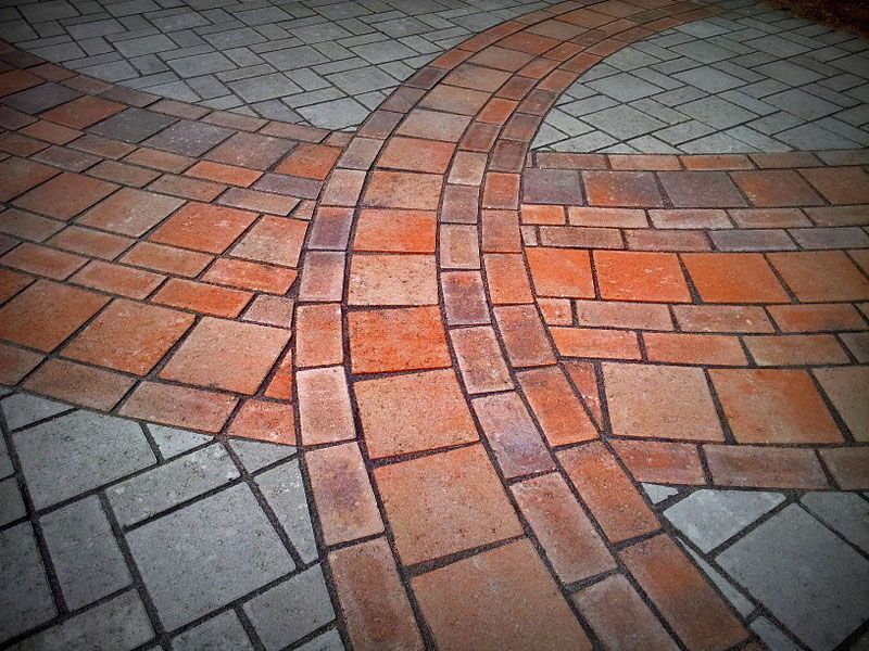 a close up of a brick floor with a circular pattern