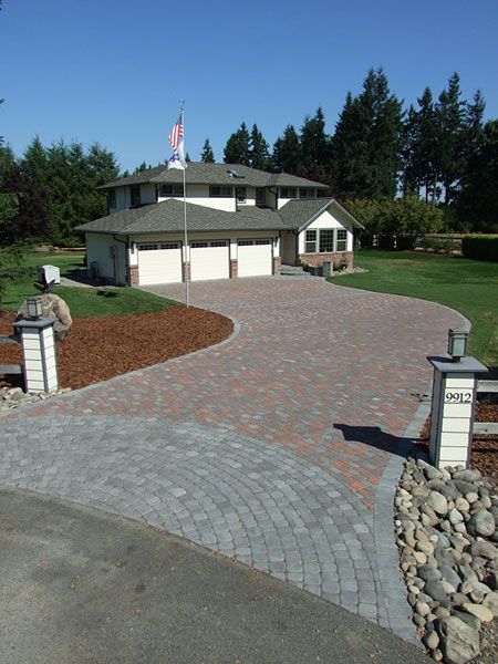 a large house with a brick driveway leading to it