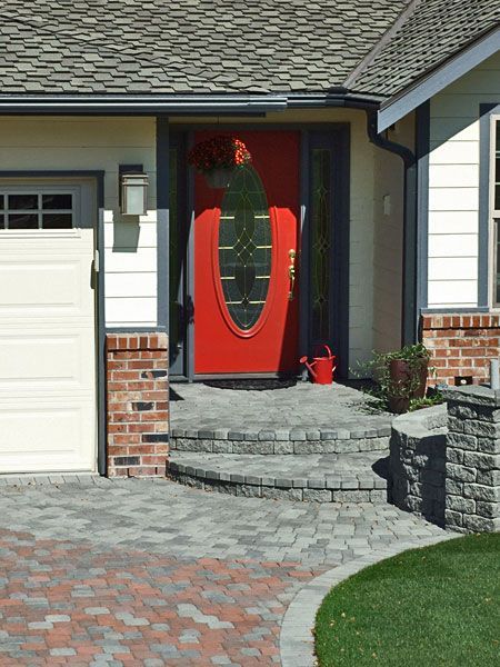a house with a red door and a white garage door