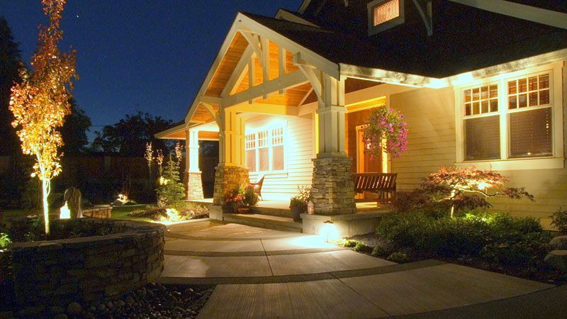 the front of a house is lit up at night