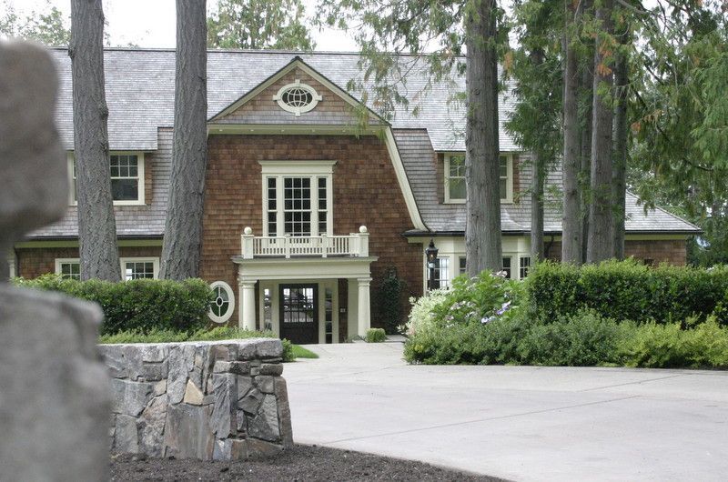 a large brick house is surrounded by trees and bushes