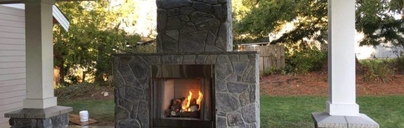 there is a fireplace in the backyard of a house