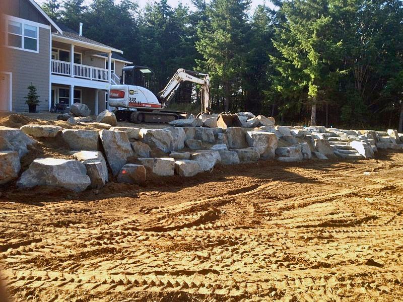a construction site with a house in the background