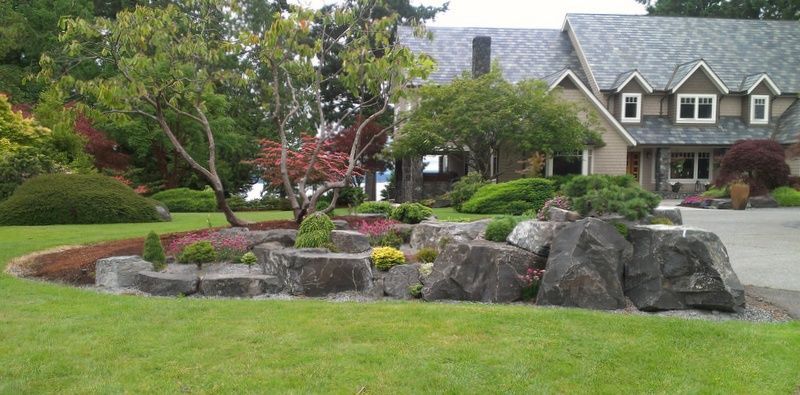 a large house with a lot of rocks in front of it