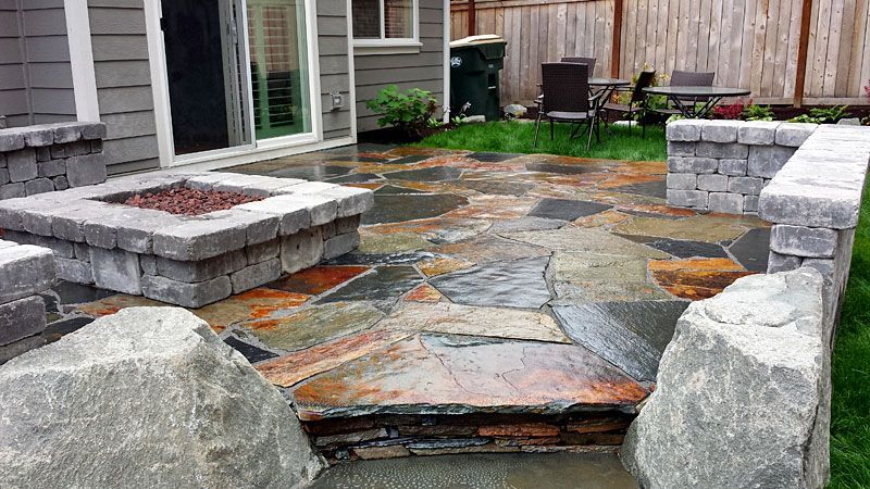 there is a fire pit in the middle of the patio