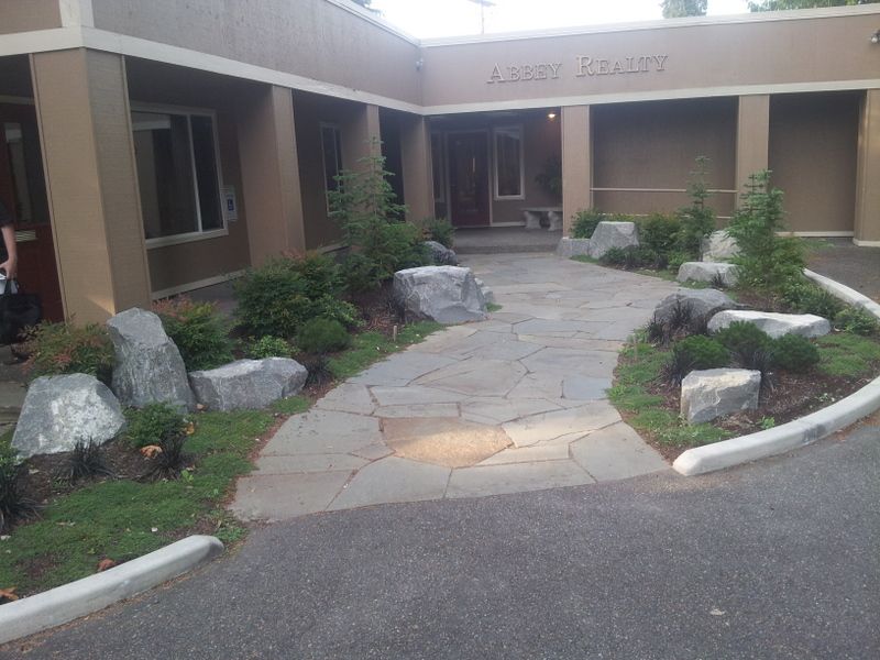 a stone walkway leading to a building that says albert county