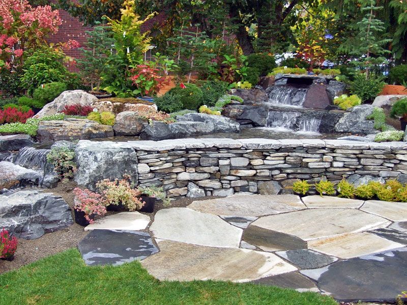 there is a waterfall in the middle of the garden