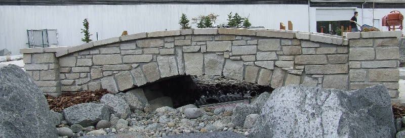 a stone bridge with a hole in the middle of it