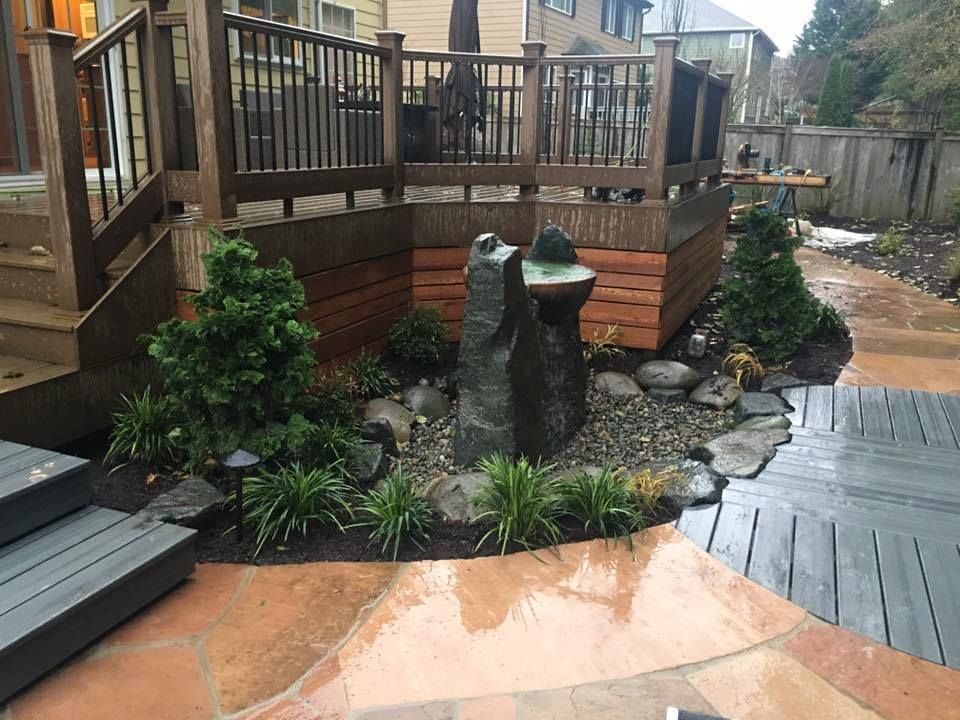 a deck with a fountain in the middle of it