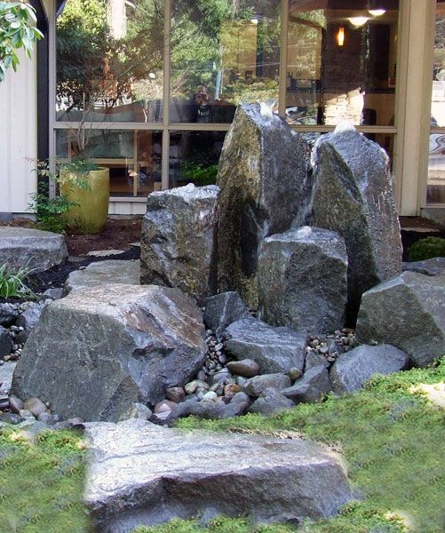 a rock garden with a large rock in the middle
