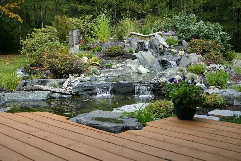 a wooden deck with a waterfall