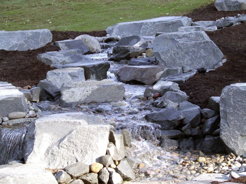 a rocky area with a stream running through it