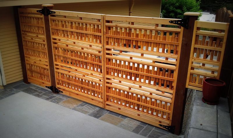 a wooden gate is sitting in front of a house