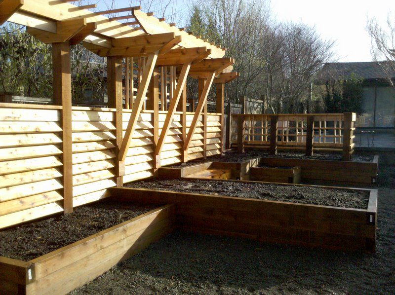 a wooden fence with a pergola