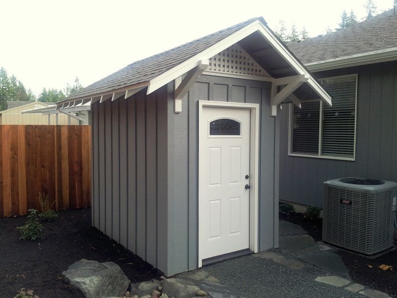 a small shed with a white door and a window