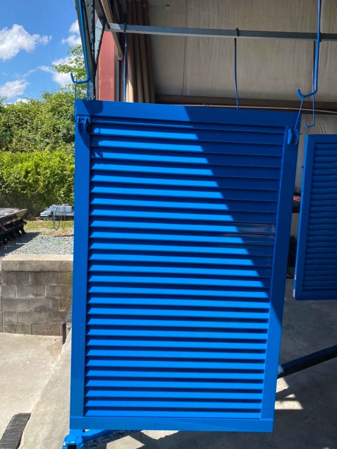 A blue shutter is sitting in front of a building