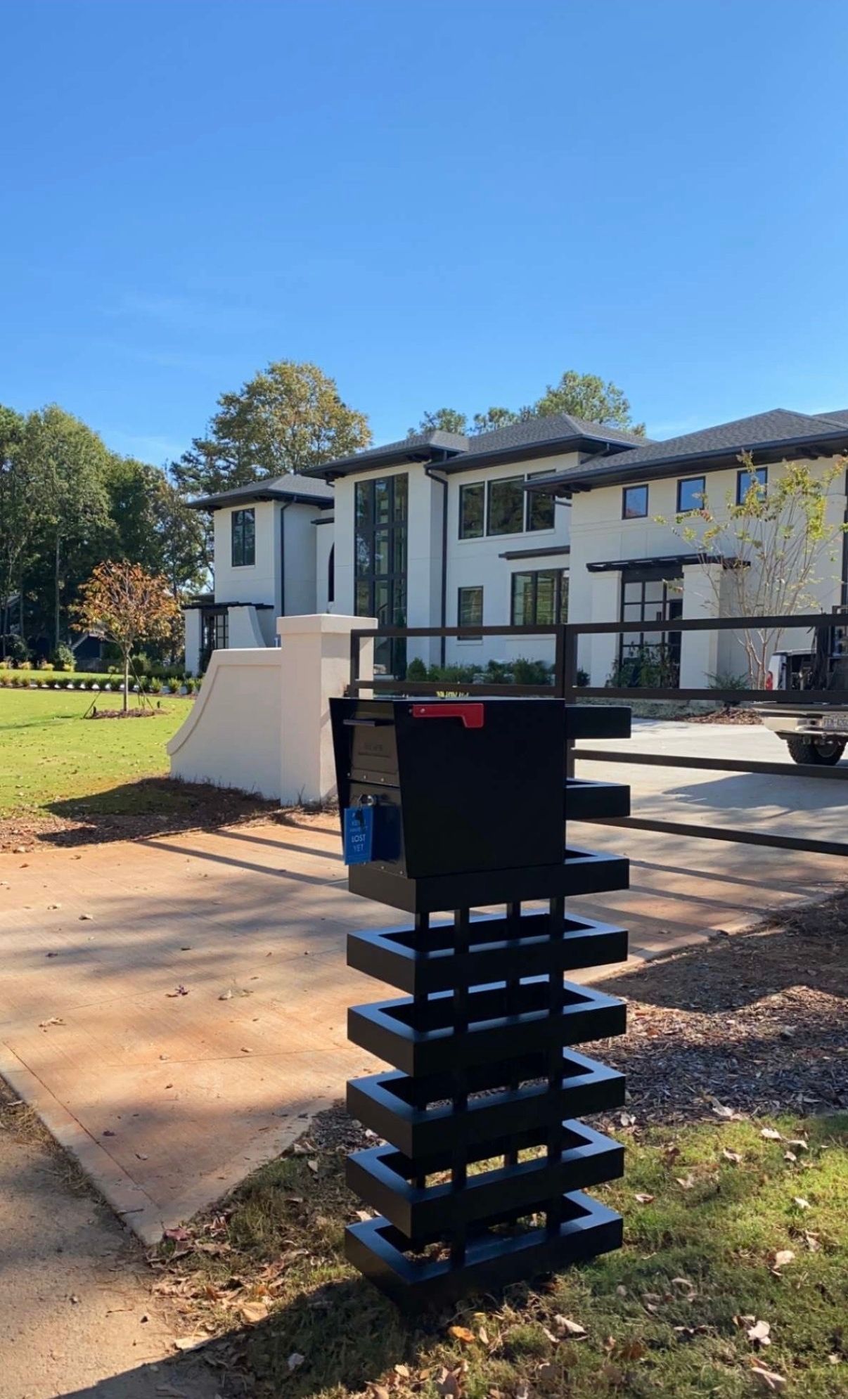 A large white house with a black mailbox in front of it.