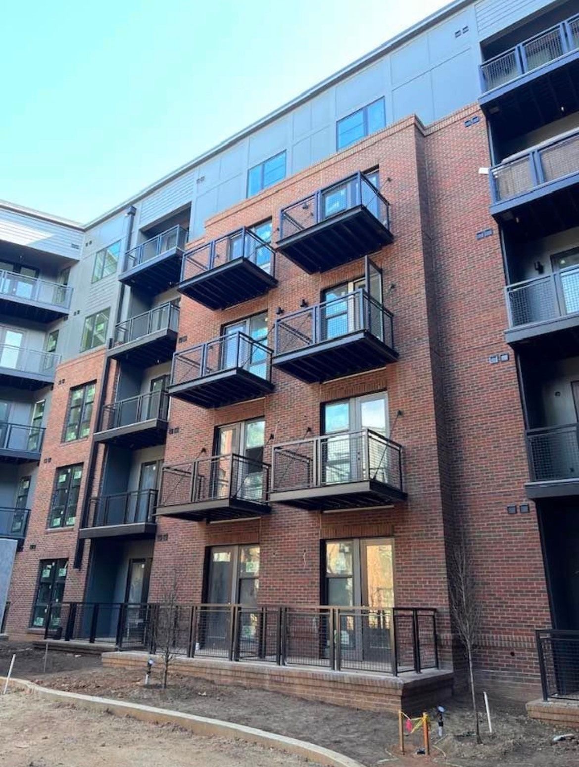 A large brick building with a lot of balconies and windows.