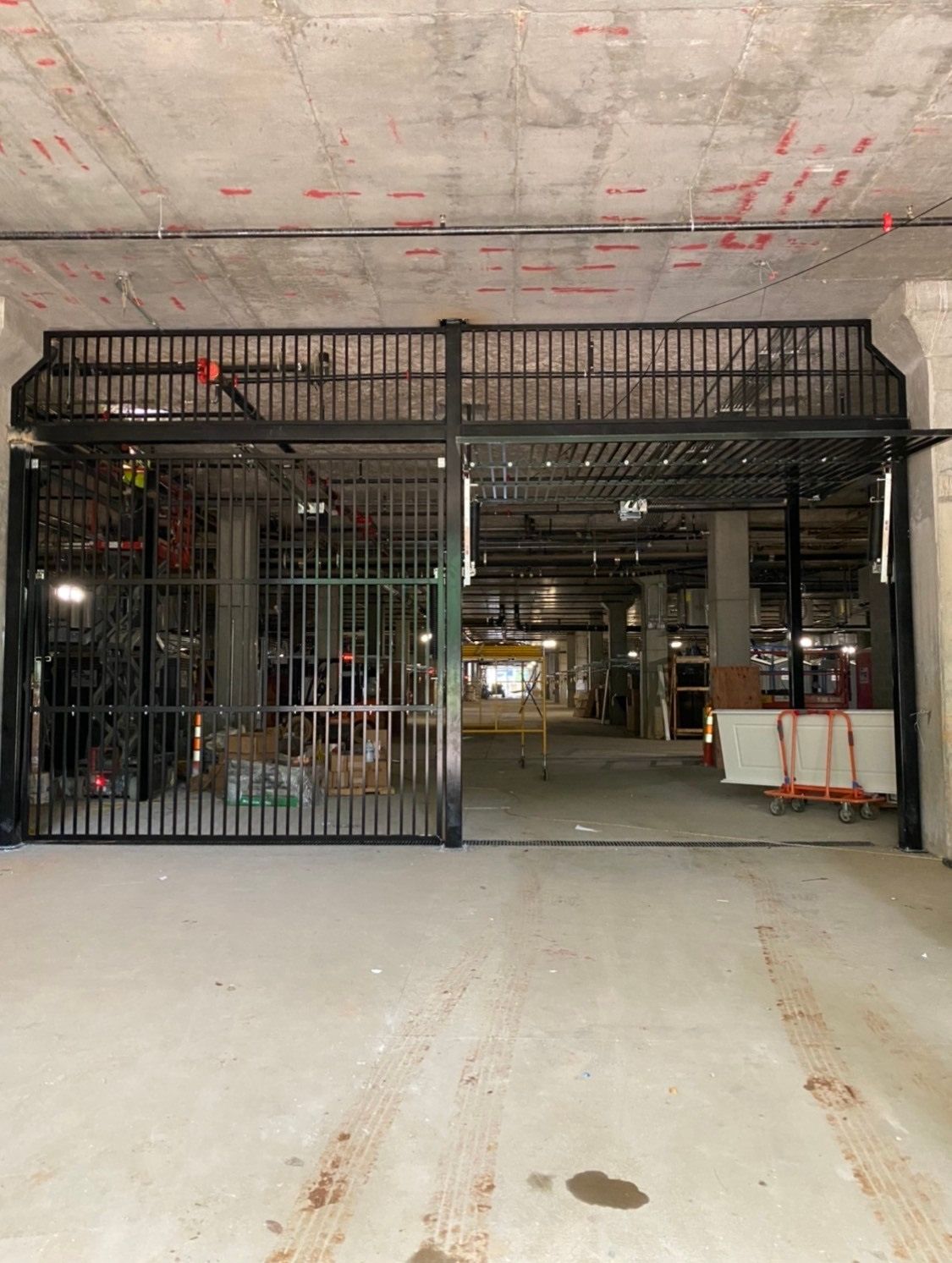 A large empty room with a gate in the middle of it.