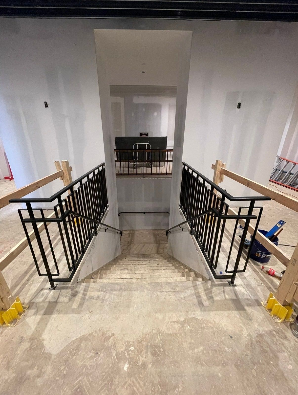 A set of stairs leading up to a second floor in a building under construction.