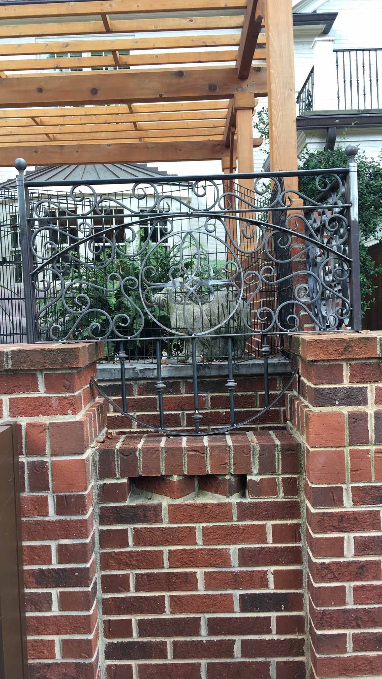 A brick wall with a wooden pergola over it.