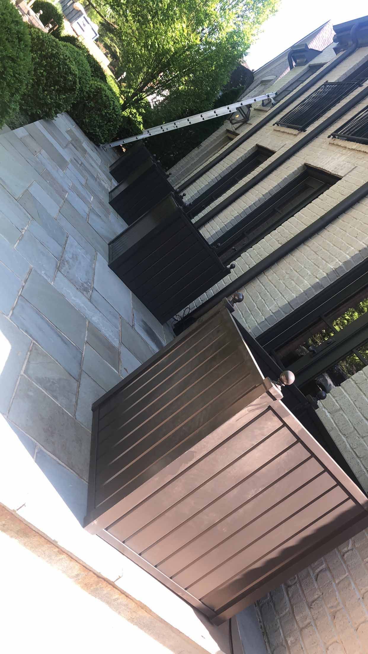 A wooden box is sitting on the side of a building.