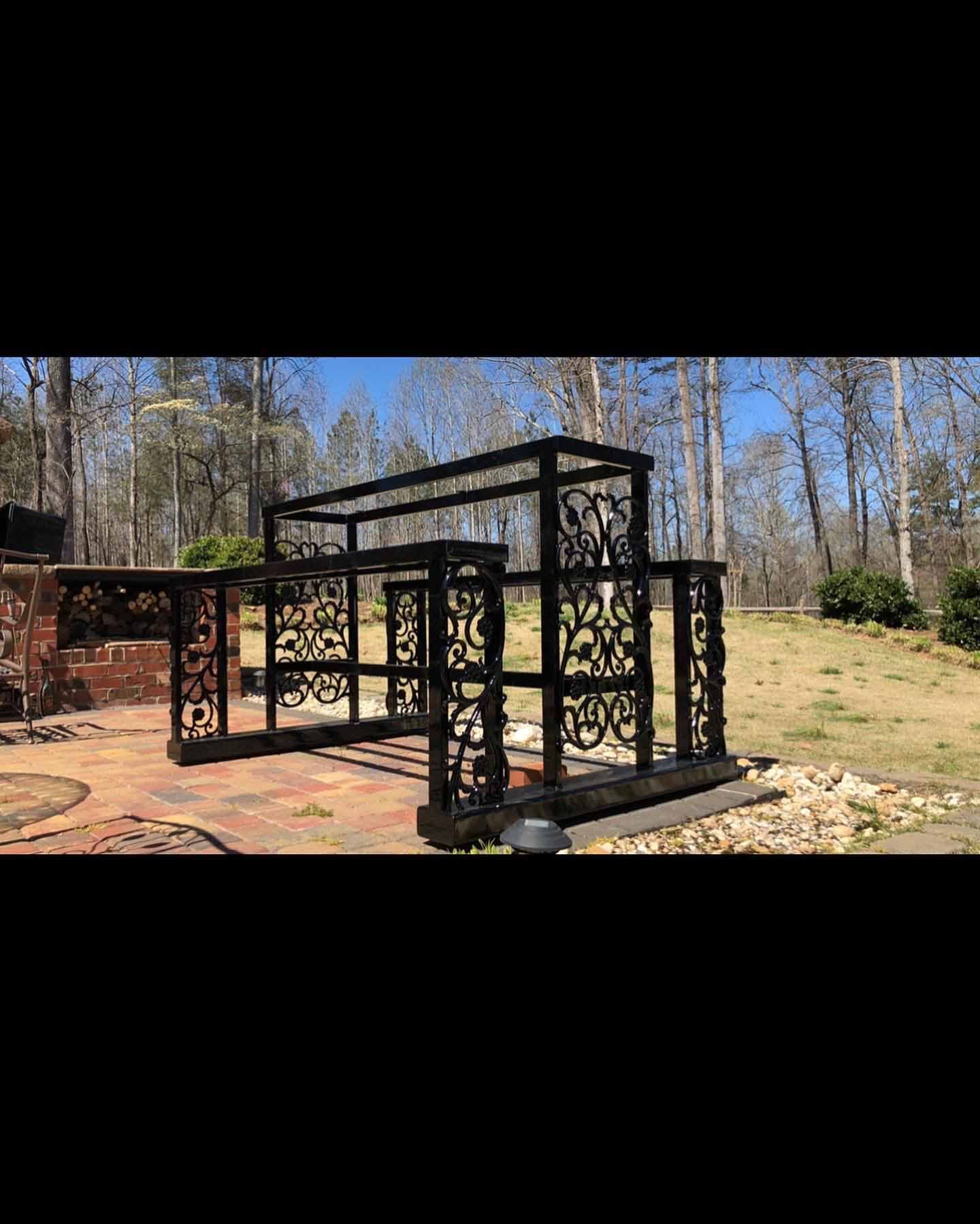 A large metal structure is sitting in the middle of a field.