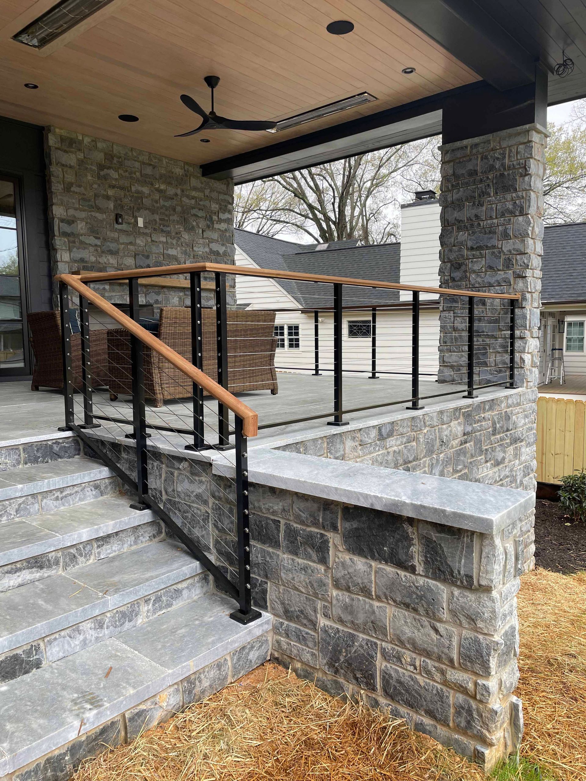 There is a staircase with a railing and a ceiling fan.