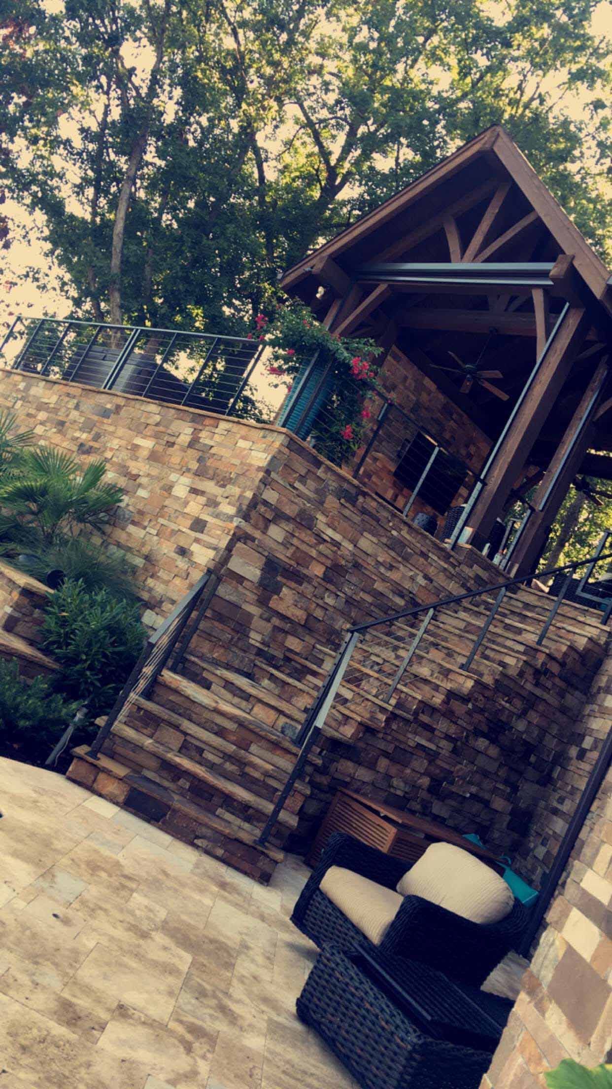 A stone building with stairs leading up to it and a chair in front of it.