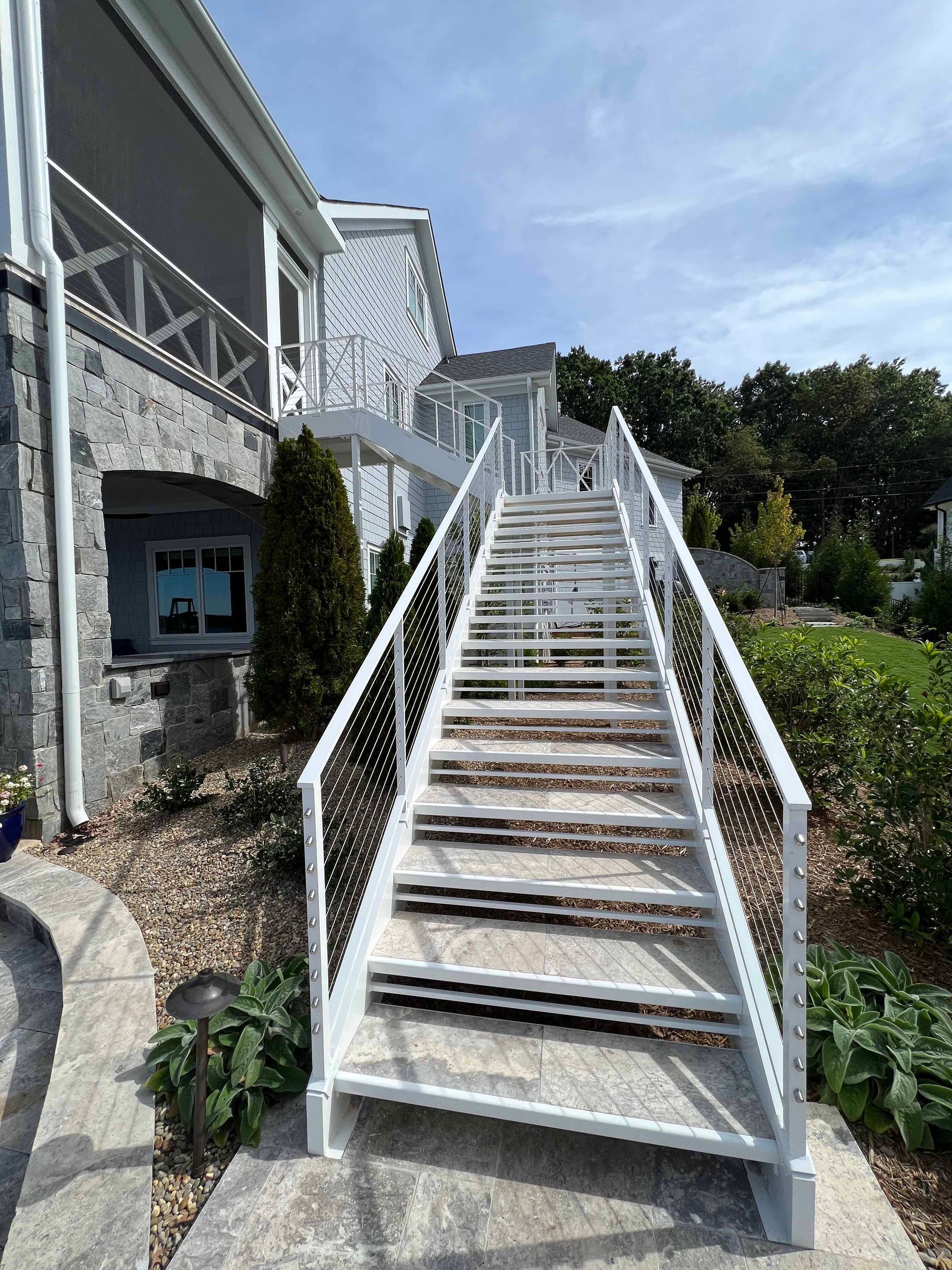 A set of white stairs leading up to a house.